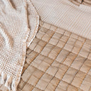 Anthology quilt close-up of  textured fabric in blocks in neutral tone