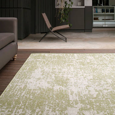 A modern living room featuring the Azulejo Moss Rug with geometric patterns in soft moss tones, enhancing the contemporary design