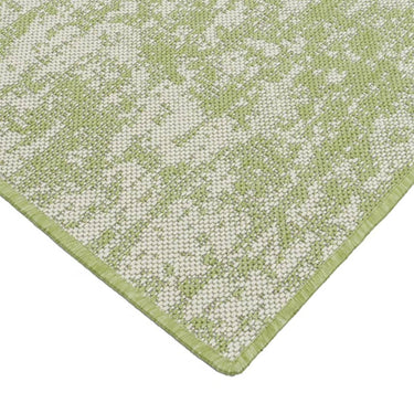 Close-up of an exquisite green rug with stylish white and grey accents, designed to elevate the aesthetic of your interior.