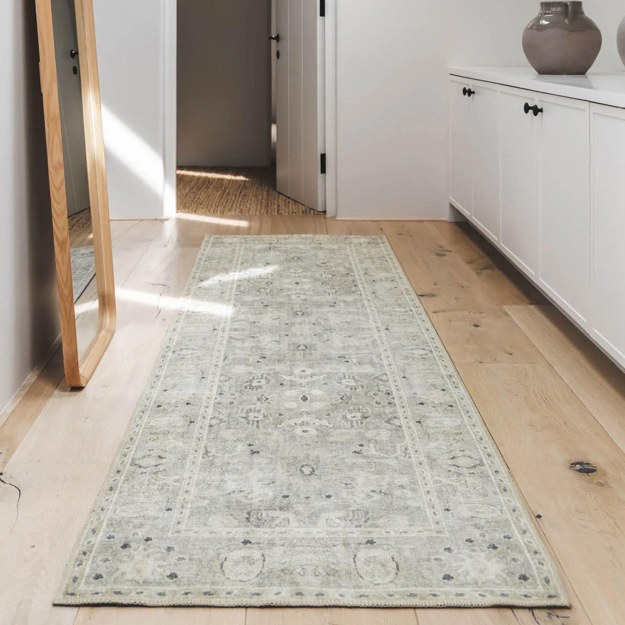 Baroness long runner rug on a wooden floor in entrance by Woodka Interiors