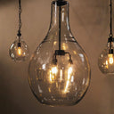 Bell glass pendant lights with visible bulbs against a neutral background
