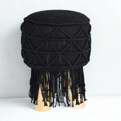Boho-style footstool with tassels and light wood base