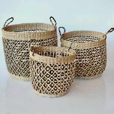 Decorative storage baskets featuring intricate black woven details.