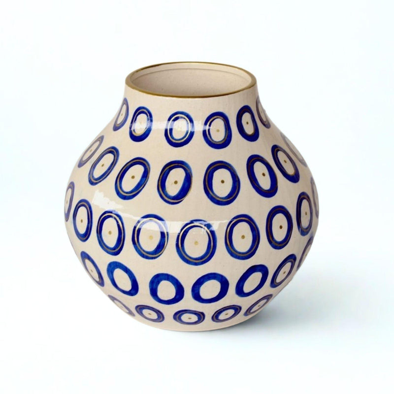 Blue circles ceramic vase with gold accents and gold-trimmed rim.