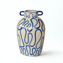 Close-up of decorative ceramic vase with squiggle detailing and glossy ceramic finish