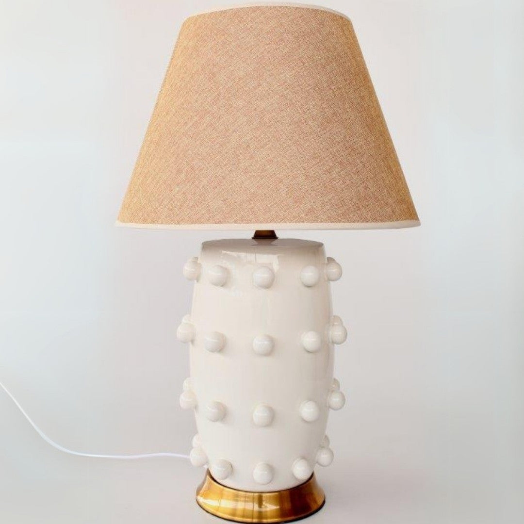 Elegant side lamps for bedroom with a brass base and beige shade.