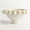 cream ceramic bowl with decorative border of raised spherical beads.
