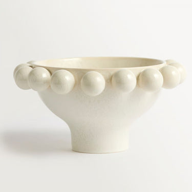 cream ceramic bowl with decorative border of raised spherical beads.