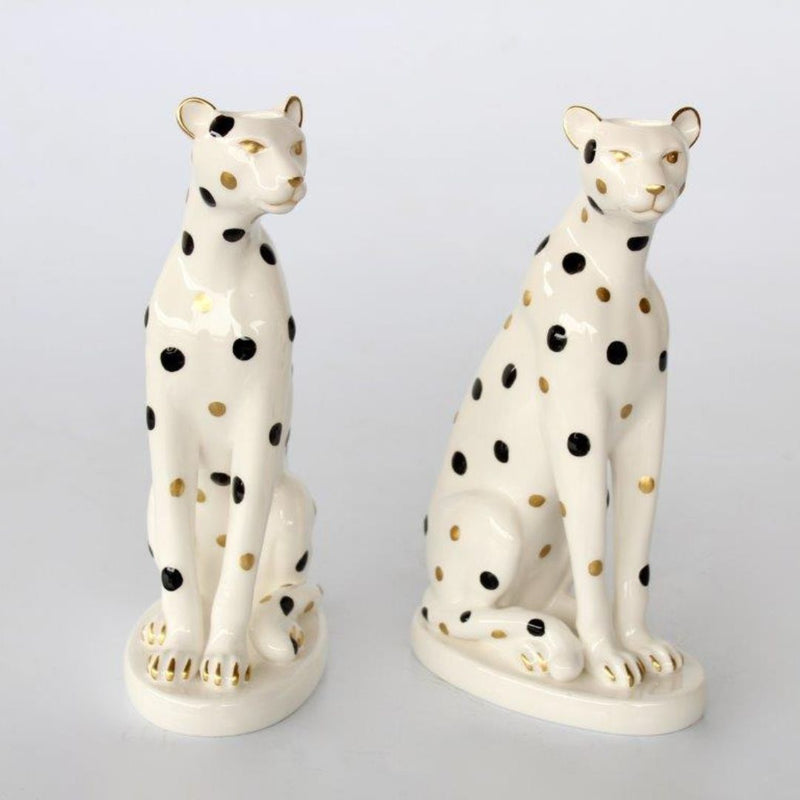 Pair of ceramic leopard candle holders designed for standard dinner candles