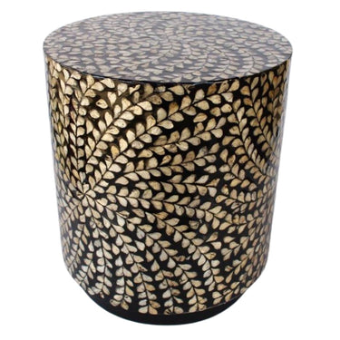 Angled view of lightweight drum-shaped accent table with shimmering gold details