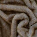 Caracul faux fur throw close-up of  the beige fur fabric texture