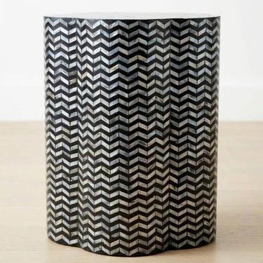Chevron shell inlay side table with black base and iridescent pattern.