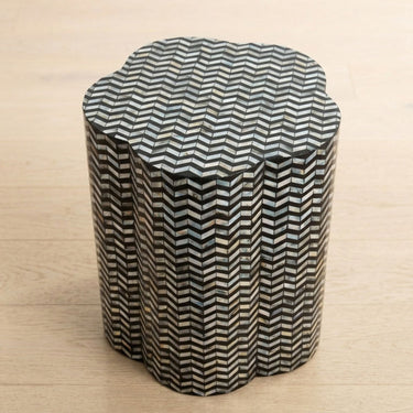 Chevron shell inlay side table top with black base and iridescent pattern.