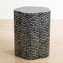 Chevron shell inlay side table with black base and iridescent pattern.