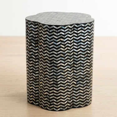 Chevron shell inlay side table with black base and iridescent pattern.