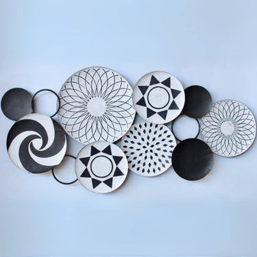 Contemporary Tonga Metal Wall Decor showcases black and white circles, inspired by Tonga baskets, perfect for luxury home decor.