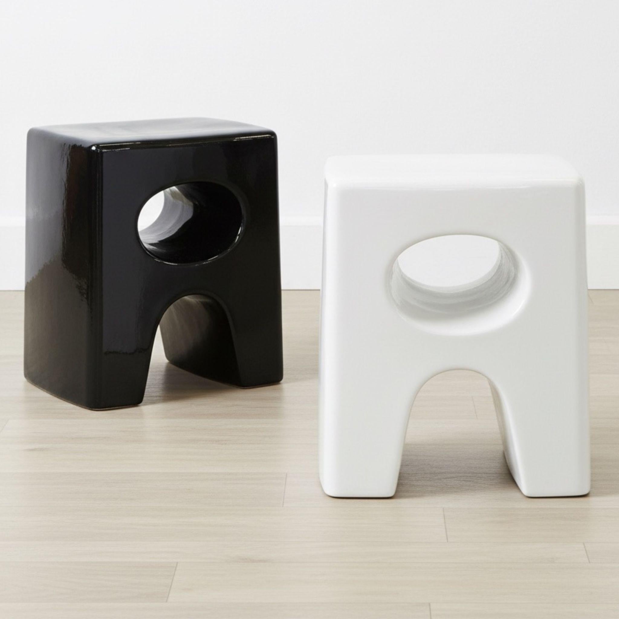 Eden Black and white ceramic stools on a light wooden floor with a white wall background by Woodka Interiors