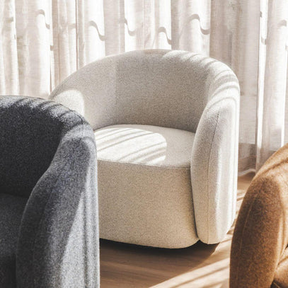 Emily Swivel Chair featured in a stylish living room, showcasing its function as a contemporary swivel armchair in Hertex Comet fabric.
