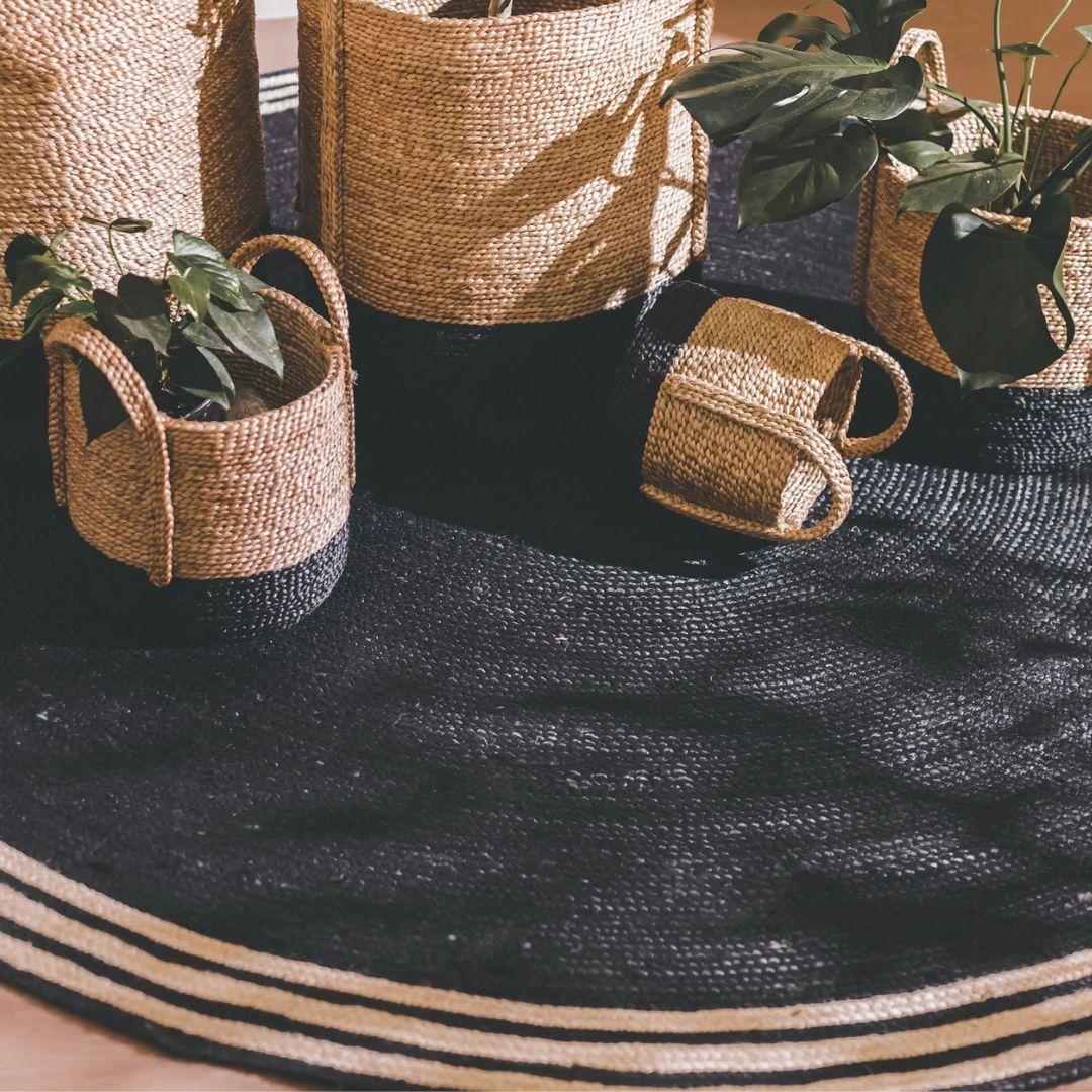 French Riviera Round Rug styled in a modern living room interior with matching decorative baskets