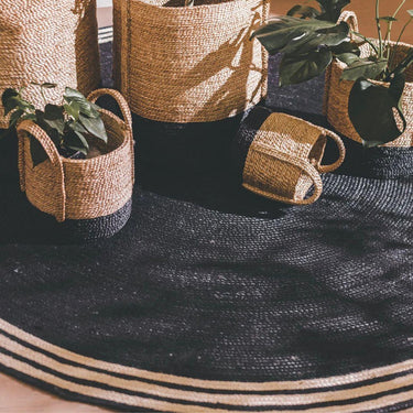 French Riviera Round Rug styled in a modern living room interior with matching decorative baskets