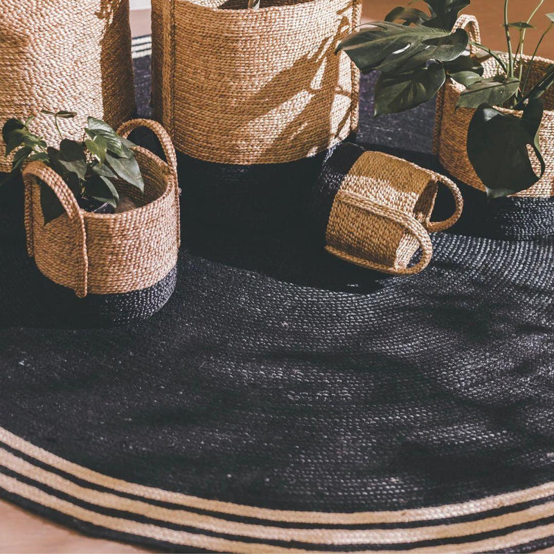 French Riviera Round Rug styled in a modern living room interior with matching decorative baskets