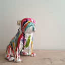 Colourful Frenchie Bulldog ceramic dog statue on a shelf.