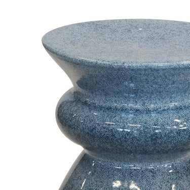 Blue decorative stool doubling as a stylish side table for any room.