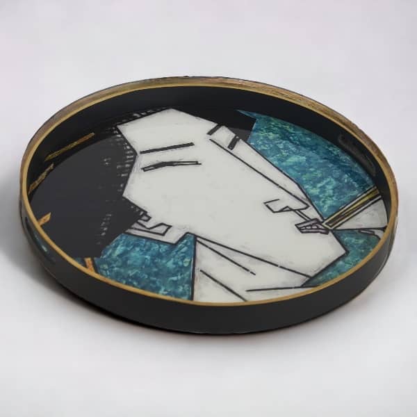 Round black decorative tray featuring art illustration of a geisha face over a blue and teal mosaic glass surface