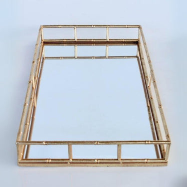 Decorative gold tray with a mirrored base, perfect for perfumes or candles.