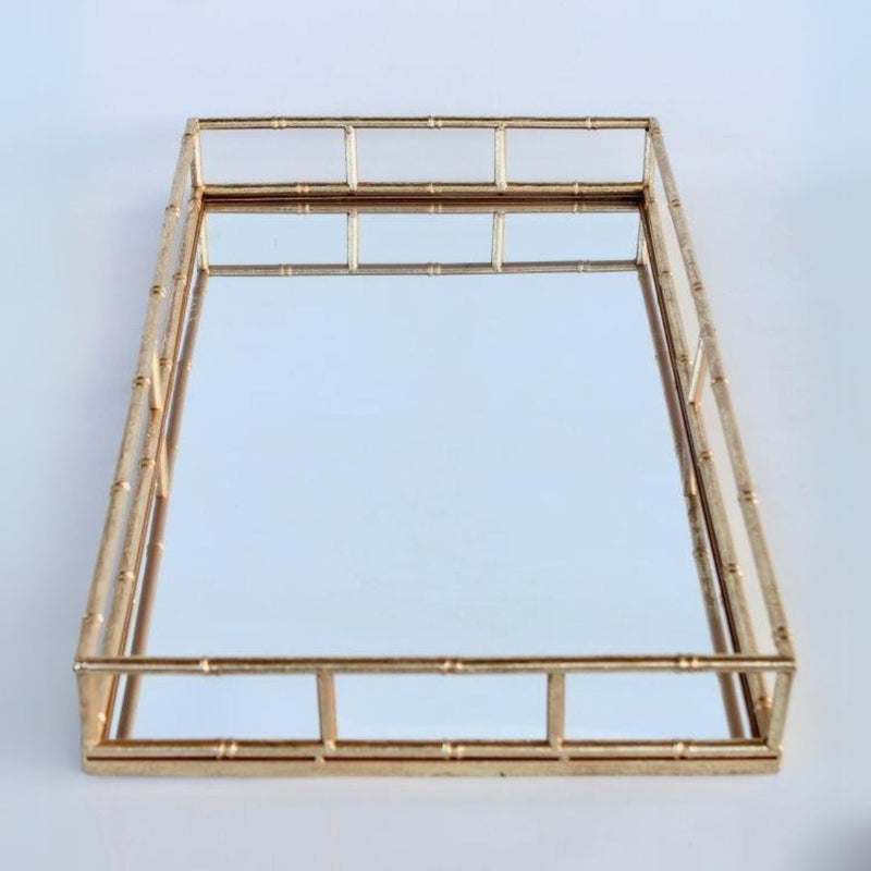 Large rectangular decorative tray with a clear mirrored base and gold-finished bamboo-effect metal frame 