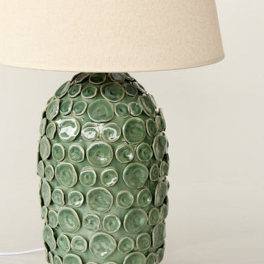 Green ceramic lamp with a textured surface
