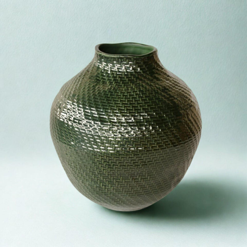 Angled image of decorative ceramic vase with glossy green glaze