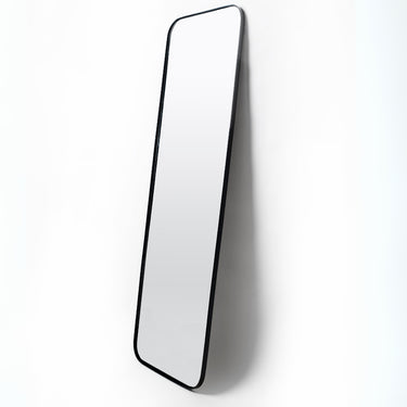 Black full-length mirror with rounded rectangular corners, matte steel frame, 180cm x 60cm, leaning or mounted.