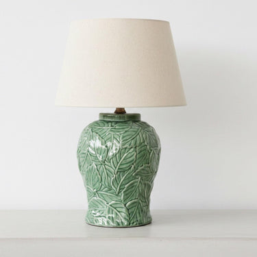 Green botanical ceramic table lamp with neutral fabric shade