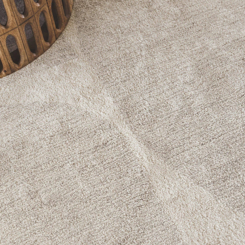 Close-up of Jupiter beige rug light neutral colours and overlapping curved blocks design.