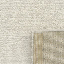 Close-up of a textured light grey rug.