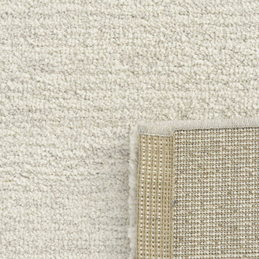 Close-up of a textured light grey rug.