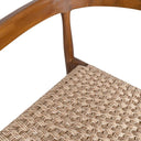 Close-up detail of the curved brown wood backrest and woven natural rope seat.
