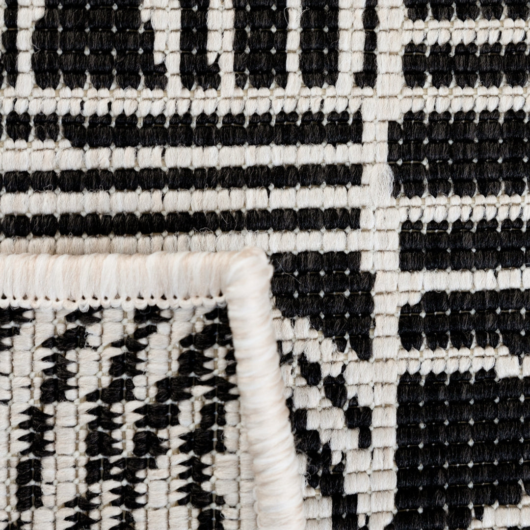 Kinky Rug in Black Sails Woodka Interiors  Close-up of the twists and turns of the Kinky Area Rug highlighting the intricate pattern that winds its way across the rug, adding depth and visual interest to any space.