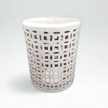 A white ceramic garden stool with pierced geometric lattice cutouts.