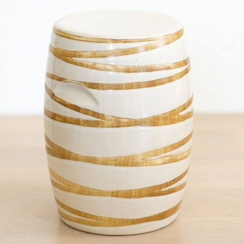 Glossy ceramic stool with subtle gold-toned linear detail. Elegant ceramic stool side table for indoor or outdoor style.