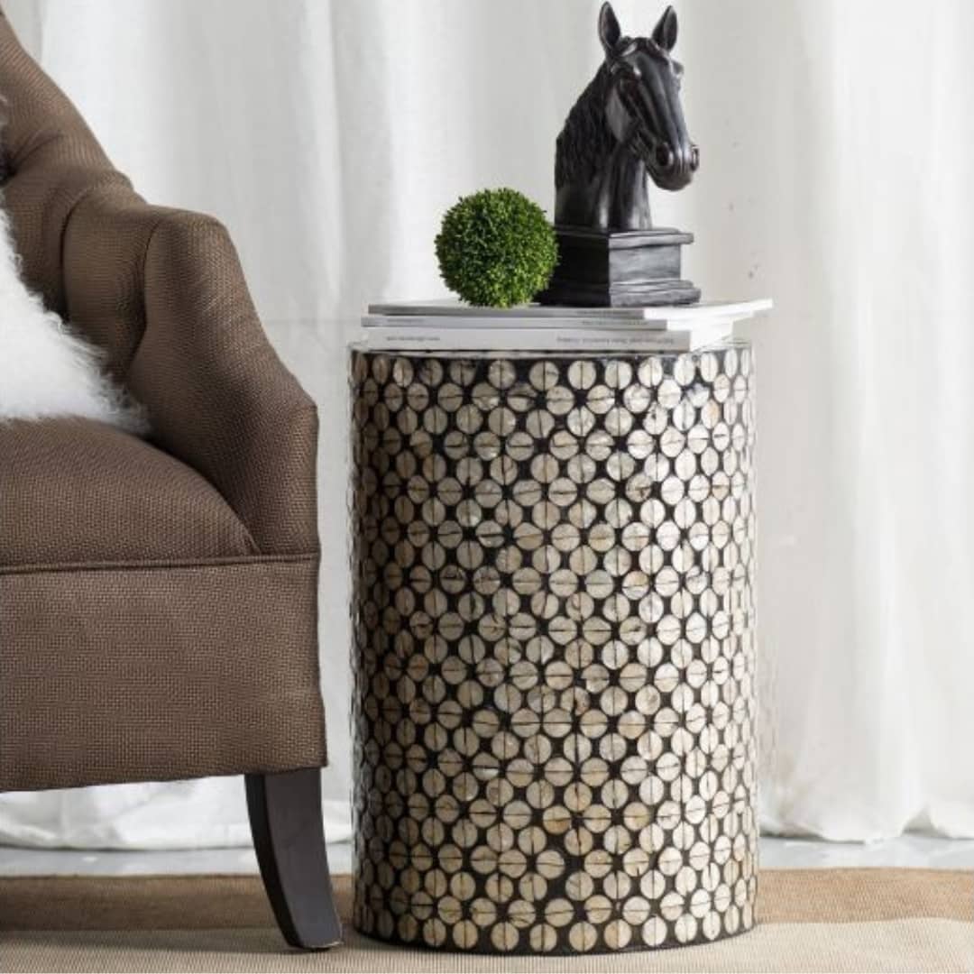 Lumina accent table styled beside couch with books and decorative horse ornament
