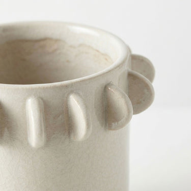 Half-moon scalloped tab edge of a small  Lunaria ivory Ceramic Vase.
