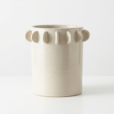 Small ivory ceramic vase with half-moon scalloped tab edge.
