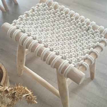 Cream macrame stool with wooden legs and knotted cotton detail, perfect for boho bedroom décor