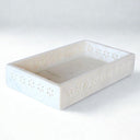 White marble vanity tray with daisy-style cutouts on all sides