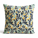Scatter Cushion in mint green background with a bold, block-print pattern of deep navy leaves and marigold yellow flowers.