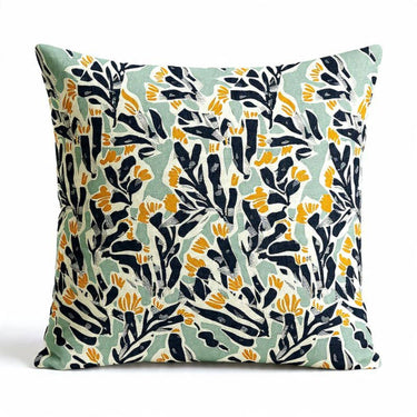 Scatter Cushion in mint green background with a bold, block-print pattern of deep navy leaves and marigold yellow flowers.