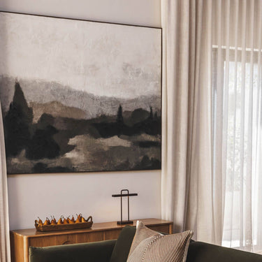 Extra large framed horizontal canvas art of a moody misty mountain landscape with forest green and beige impasto brushstrokes for living room decor.