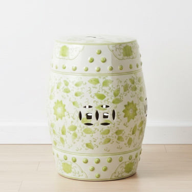 Decorative ceramic stool with green floral patterns and luck coin cut out design from Woodka Interiors